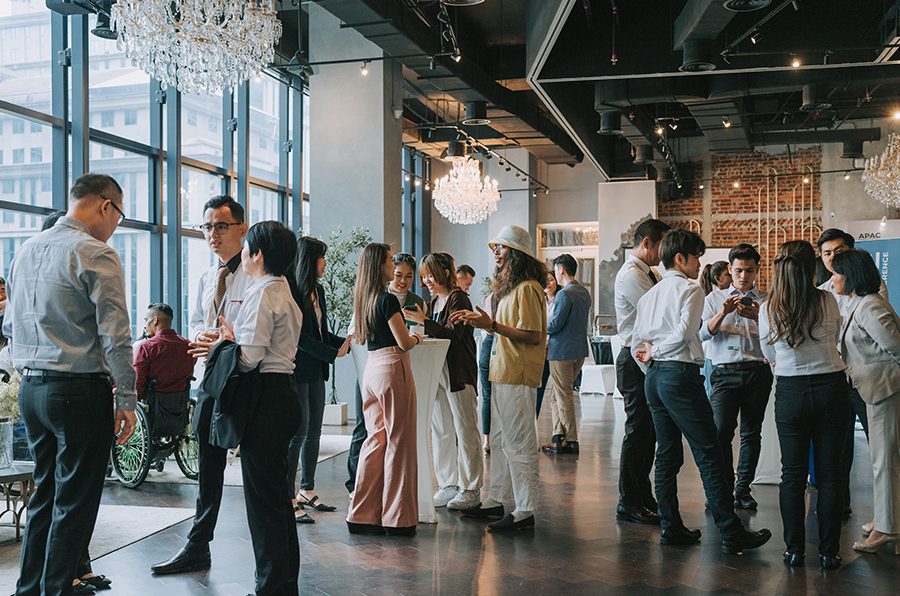 Multiple group of people at an association event gathering talking to each other